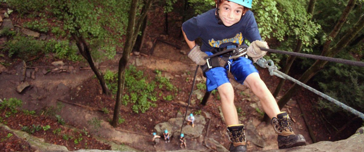 Kid rappelling in the New River Gorge, WV
