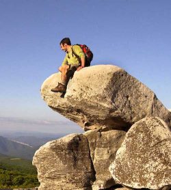 A hiker sits on a boulder in Dolly Sods, West Virginia