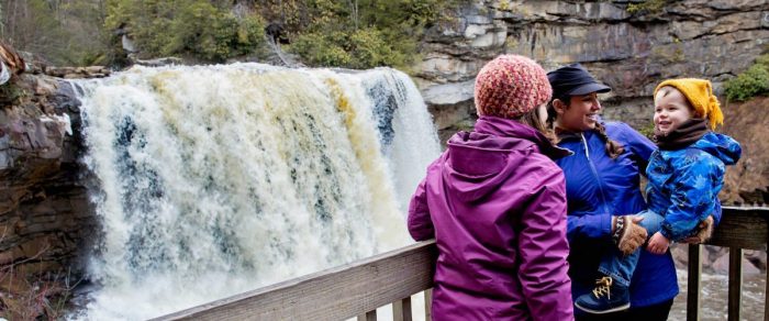 mountain traditions to share with your family. A young child visits Blackwater Falls from platform, WV