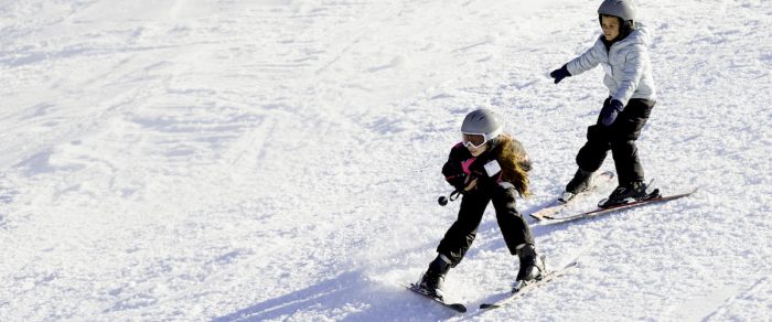 Two young girls practicing snowplow stops in West Virginia