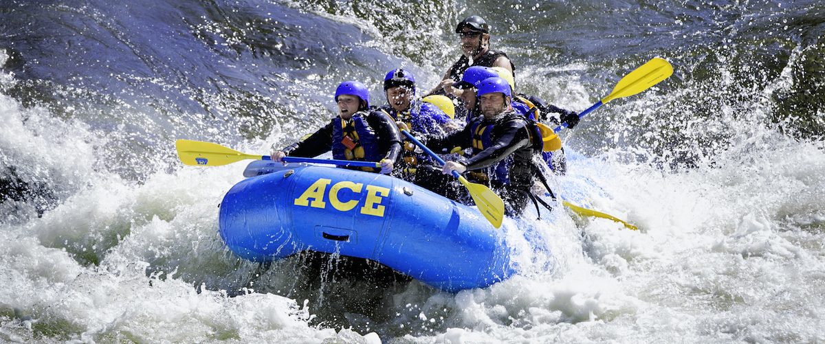Team of whitewater rafters in foaming rapids, WV
