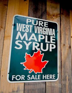 A sign that says, "Pure West Virginia maple syrup for sale here." 