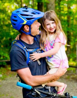 Father and daughter riding bike at Arrowhead Bike Farm, WV