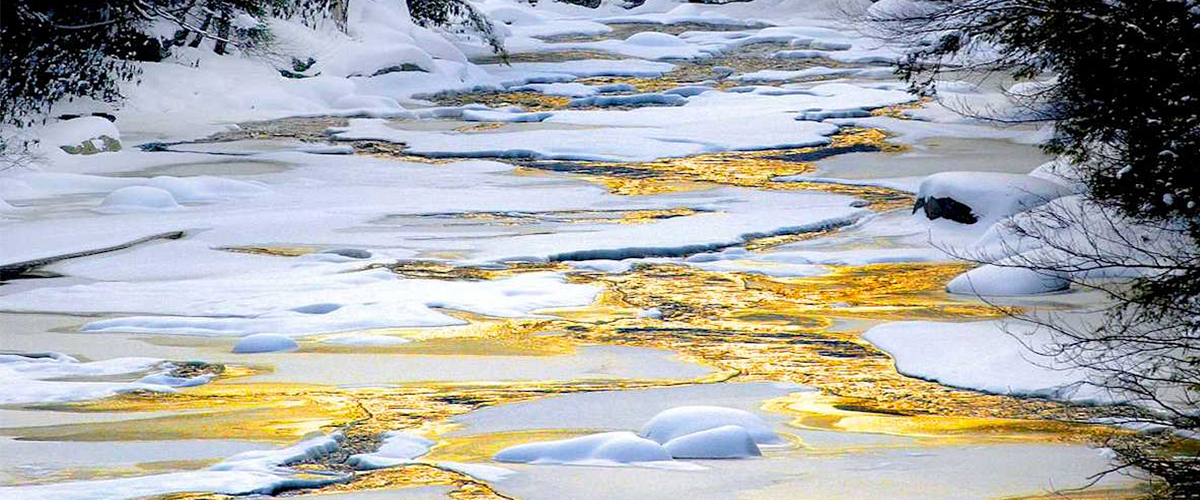 A frozen river turns golden at sunset, Blackwater Falls State Park, WV