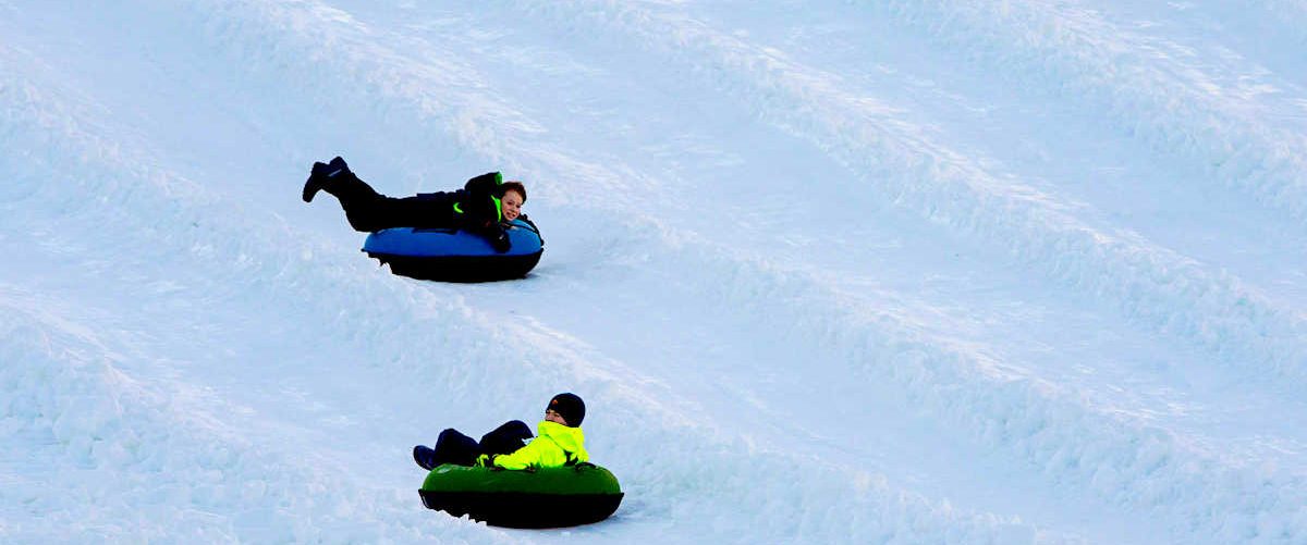 Two boys going tubing down Winterplace's tubing lanes, WV
