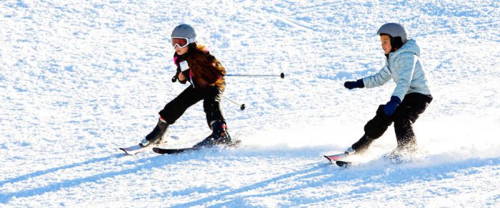 Two young girls learning to ski in West Virginia