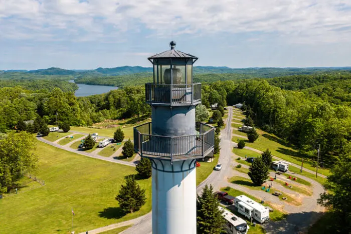 Tall observation tower overlooking campground roads and wooded landscape