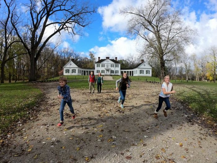 Children running with Blennerhassett Island Mansion in the background