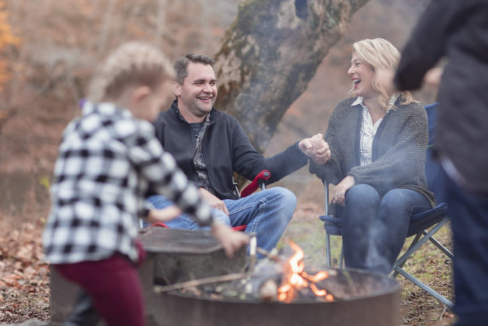 A family safely enjoys a campfire.