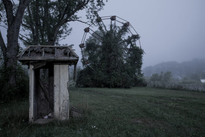 An abandoned ferris wheel covered in overgrowth still stands at Lake Shawnee. 