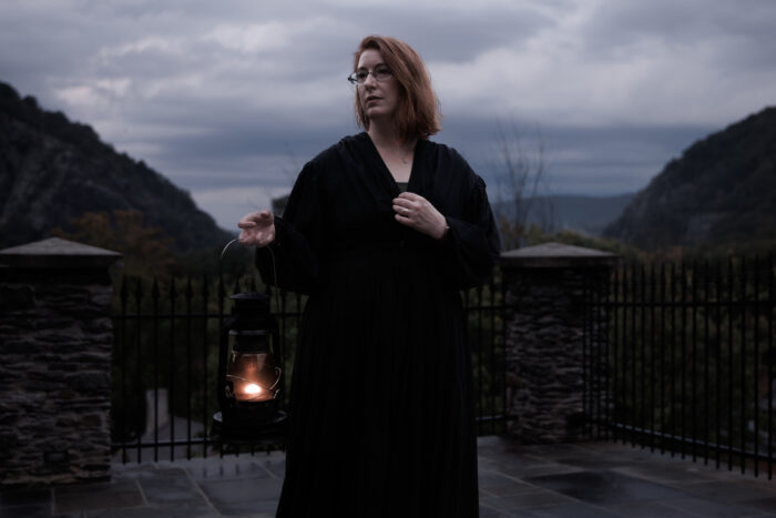 The ghost tour guide in Harpers Ferry, WV holds an old-fashioned lantern as she shares tales of the unexplained