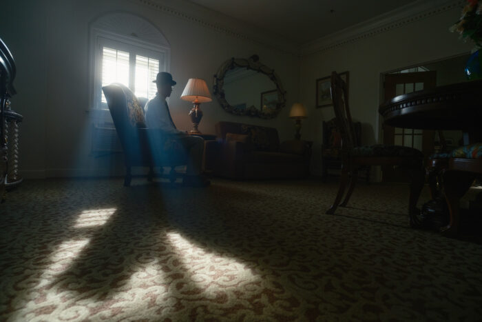 A man in a bowler hat sits at The Blennerhassett Hotel. The man is portraying one of the hotel's most famous ghosts.