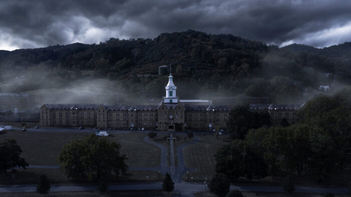 Dark clouds settle over the Trans-Allegheny Lunatic Asylum building and grounds